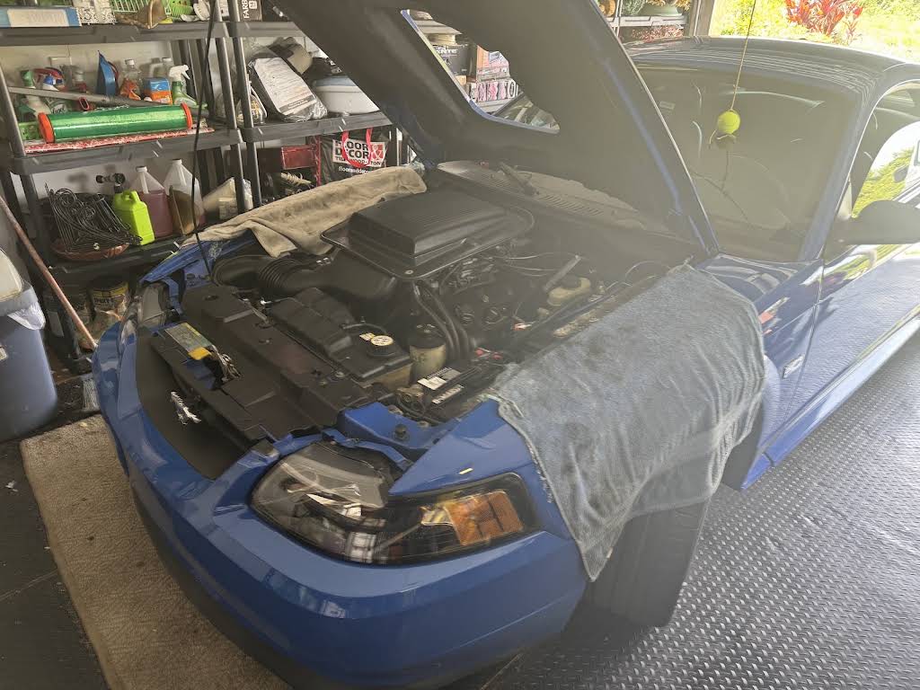 Mustang with its hood open during a no-start repair in a customer's own garage